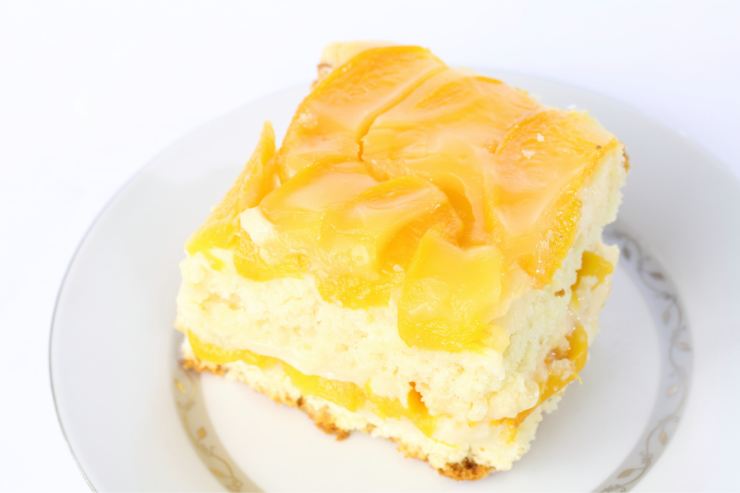 dolce con le pesche e crema nel piattino