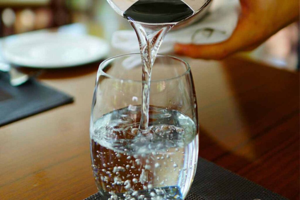 versare acqua in bicchiere, sfondo piatti